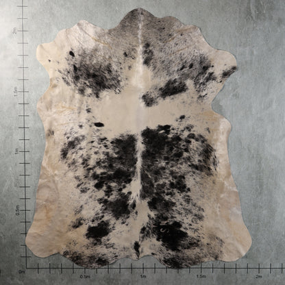 Cream and black mottled Nguni hide with irregular dark patches and fine grey-black speckling, genuine South African cowhide – AAS8342.