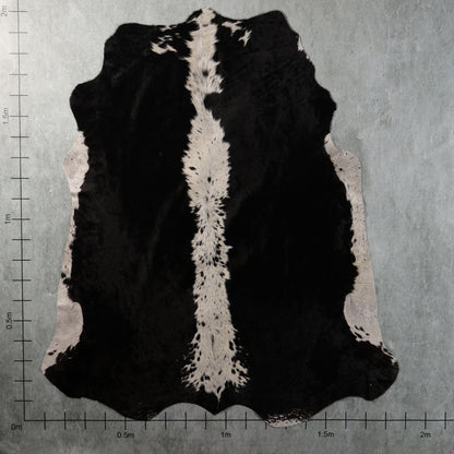 Genuine South African black-and-white Nguni cowhide with bold black panels, a distinctive white speckled central stripe and contrasting white side markings – BGS2750.