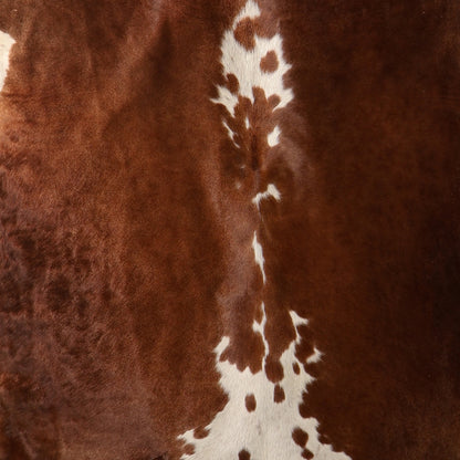 close up of a Genuine South African Nguni hide AAG5385 in chestnut brown and cream with distinctive central white markings.