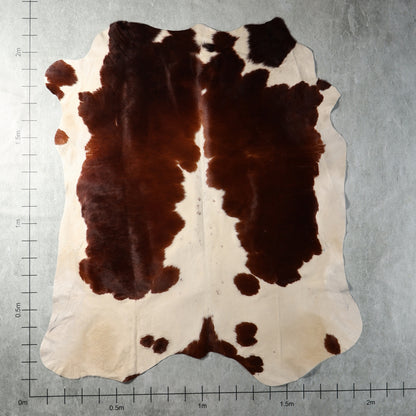 Genuine South African Nguni hide AGD7165 in dark brown and cream with bold irregular contrasting patches.