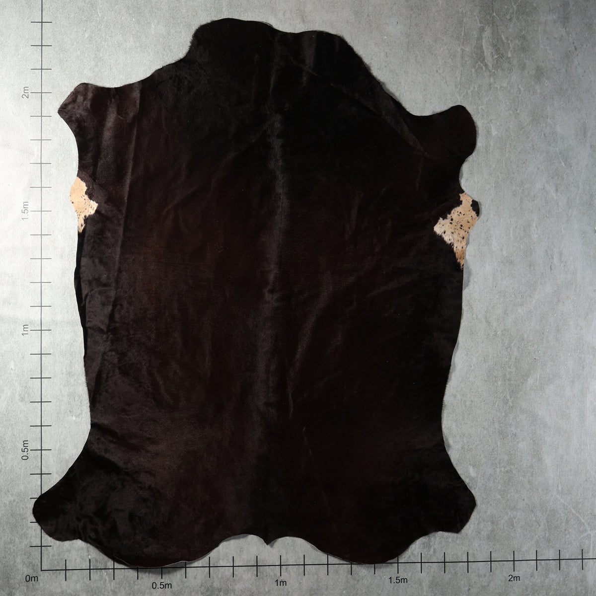 Predominantly solid black genuine South African Nguni cowhide AGD7185 with deep natural dark colouring.