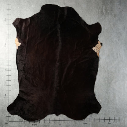 Predominantly solid black genuine South African Nguni cowhide AGD7185 with deep natural dark colouring.