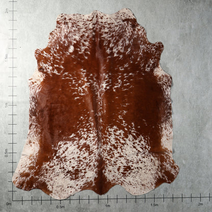 Genuine South African Nguni hide AGS7396 in reddish brown and white with dense speckled markings and warm chestnut tones.