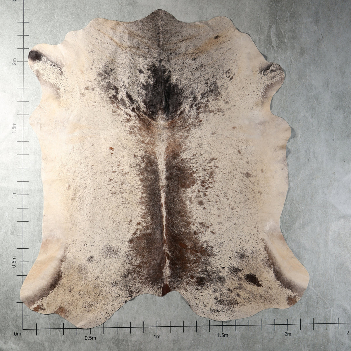 Cream, smoky grey and brown speckled genuine South African Nguni cowhide AGS7405 with distinctive dark central markings.