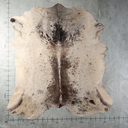 Cream, smoky grey and brown speckled genuine South African Nguni cowhide AGS7405 with distinctive dark central markings.