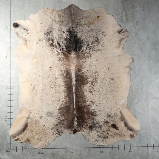 Cream, smoky grey and brown speckled genuine South African Nguni cowhide AGS7405 with distinctive dark central markings.