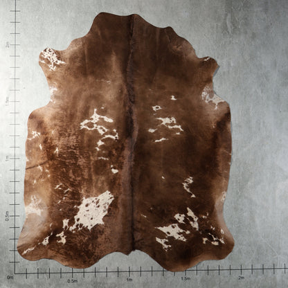 Genuine South African Nguni hide AGS7406 in chocolate brown with irregular white patches and warm natural brown tones.