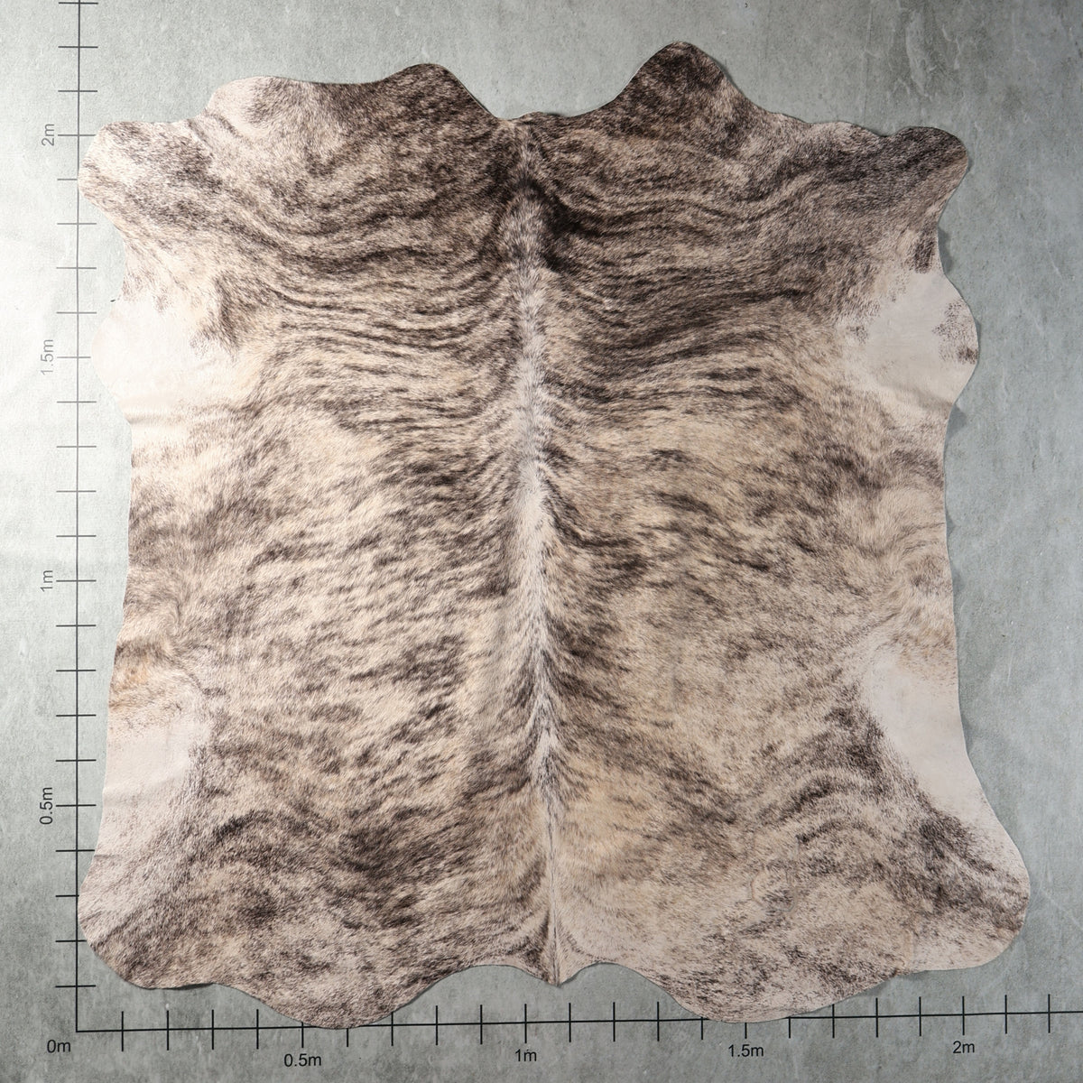 Grey and cream brindle genuine South African Nguni cowhide AGS7410 with flowing charcoal stripes and natural mottled markings.