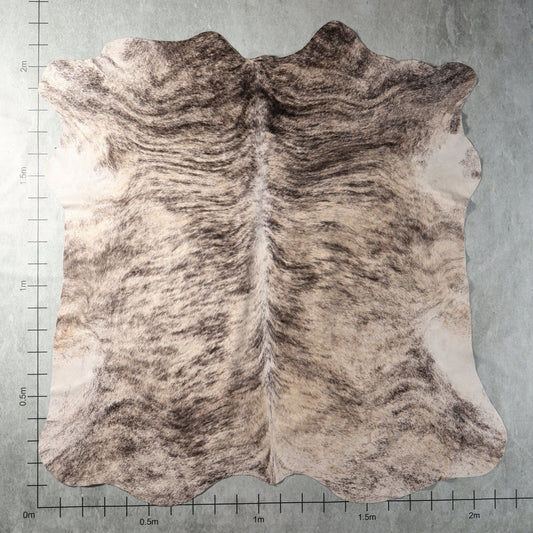 Grey and cream brindle genuine South African Nguni cowhide AGS7410 with flowing charcoal stripes and natural mottled markings.