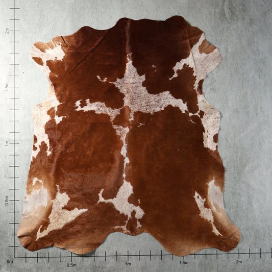 Genuine South African Nguni hide AGS7416 in chestnut brown and white with large contrasting patches and irregular central markings.