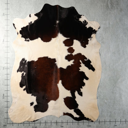 Genuine South African Nguni hide BGS2739 featuring bold black, dark brown and creamy white patches in an irregular pattern.