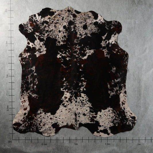 Genuine South African tri-colour Nguni cowhide with bold black and reddish-brown patches and dense white speckled markings – TRI2852.