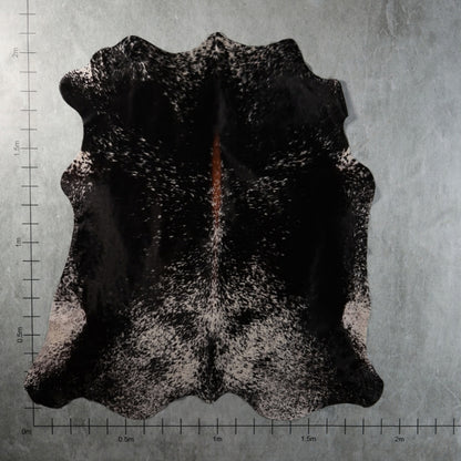 Genuine South African black-and-white speckled tri-colour Nguni hide with a distinctive reddish-brown central streak and finely mottled markings – TRI2856.